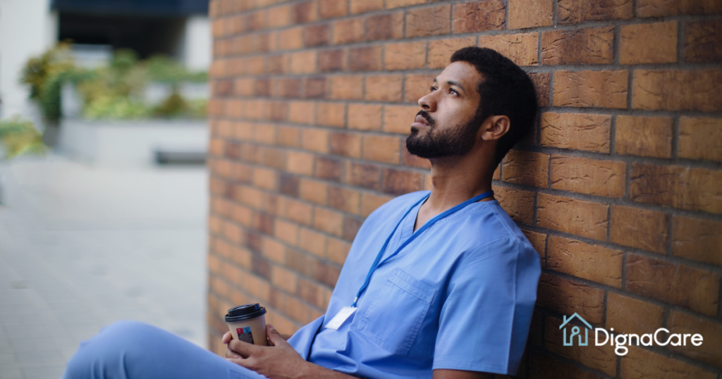 An exhausted professional caregiver takes a break outside.