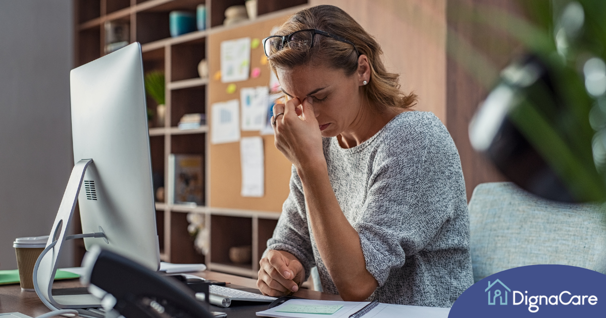 A woman is exhausted at her job as a result of struggling with balancing caregiving and her career.